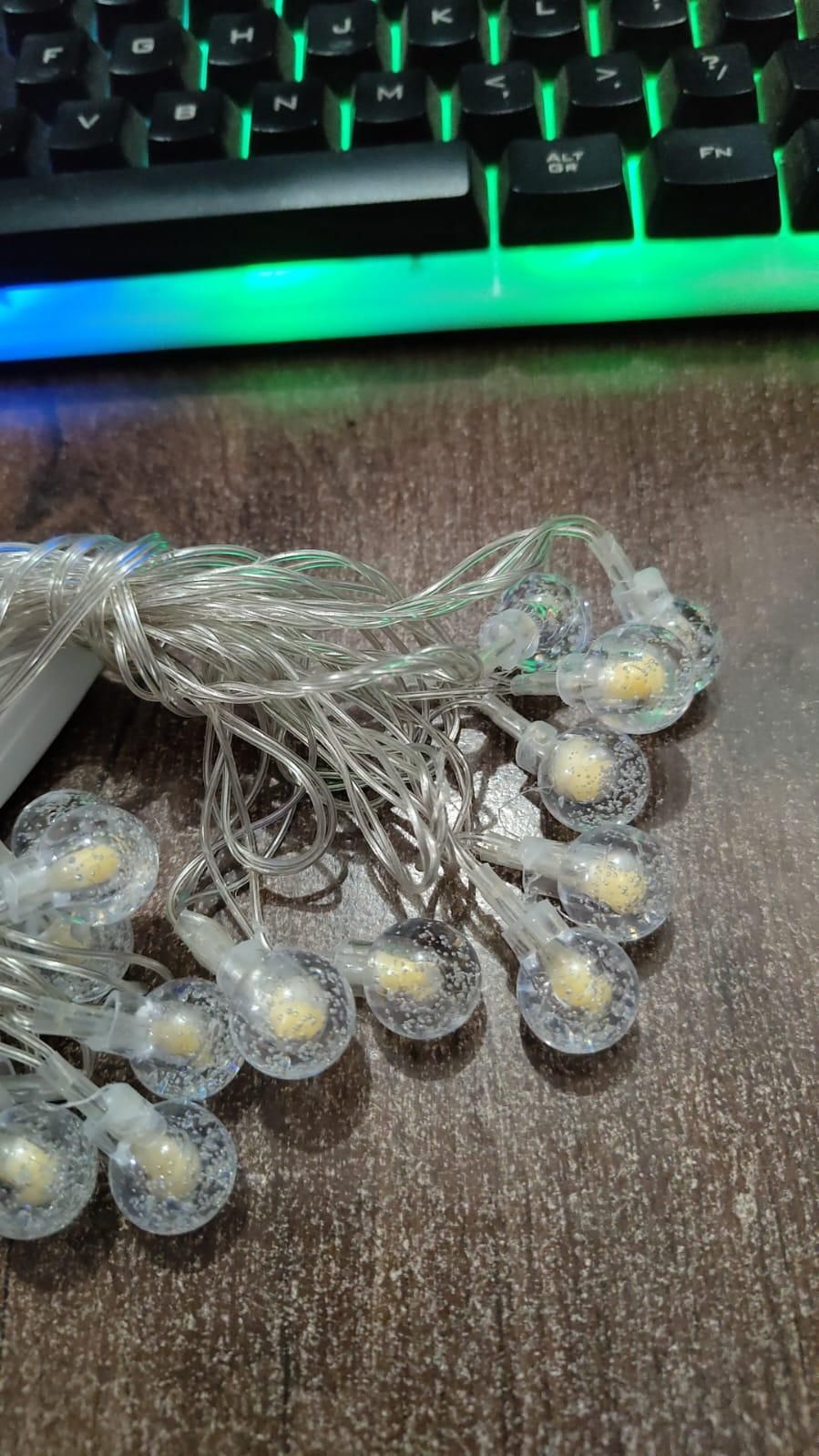 16 LED Crystal Balls String Lights in yellow, perfect for Diwali, Christmas, weddings, parties, and home decoration. High-brightness AC powered lights with shimmery crystal glass balls, portable and safe for indoor and outdoor use, 3-meter string, 16 LEDs, warm glow, magical ambiance.