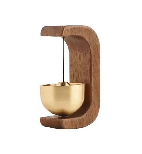 Decorative item with a copper  bowl  and bell and wooden holder for home entrance,positive energy feng shui  hanging bell on a white background