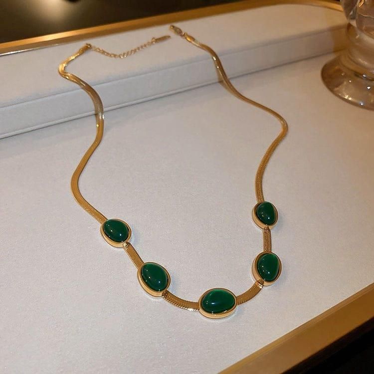 Stylish gold necklace and bracelet set with oval green crystal for women