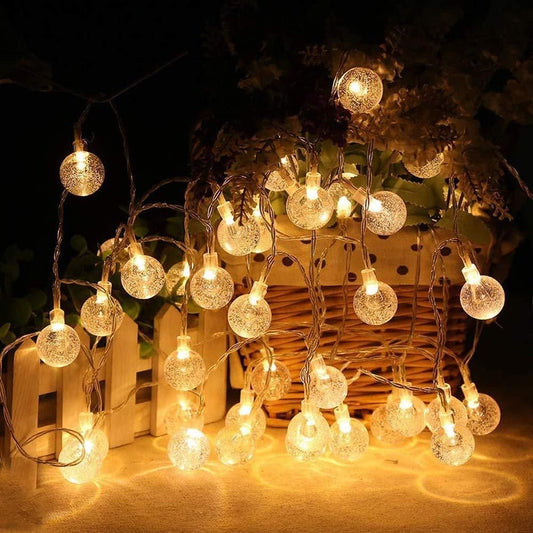 16 LED Crystal Balls String Lights in yellow, perfect for Diwali, Christmas, weddings, parties, and home decoration. High-brightness AC powered lights with shimmery crystal glass balls, portable and safe for indoor and outdoor use, 3-meter string, 16 LEDs, warm glow, magical ambiance.

