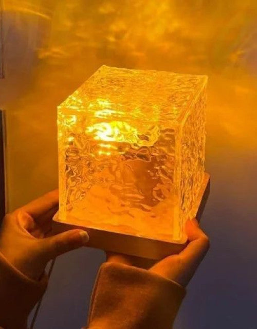 Rotating Water Ripple Night Light Aura Lamp projecting multicolor LED waves in a cozy bedroom